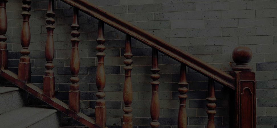 Tailored wooden stair banister fitted with a concrete staircase.