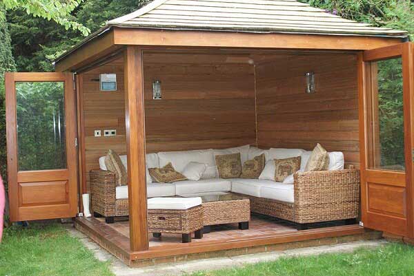 Bespoke wooden outhouse situated in a garden space.